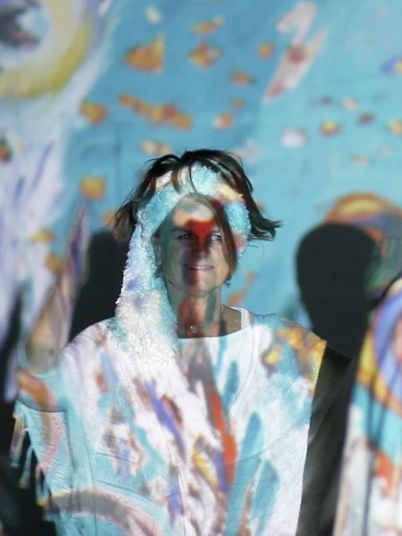 Eva Ariela dancing with dancers infront of her 5th Dimensional Art multi media style